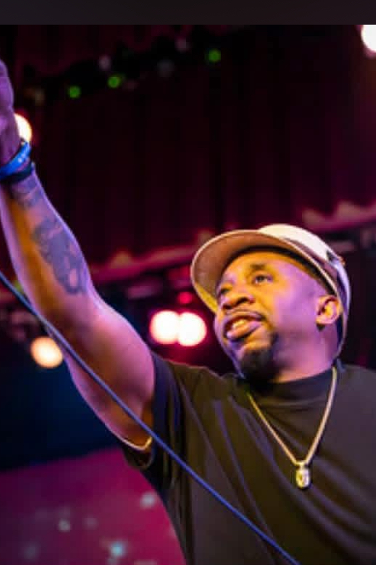 Rodney Dukes on stage, holding microphone