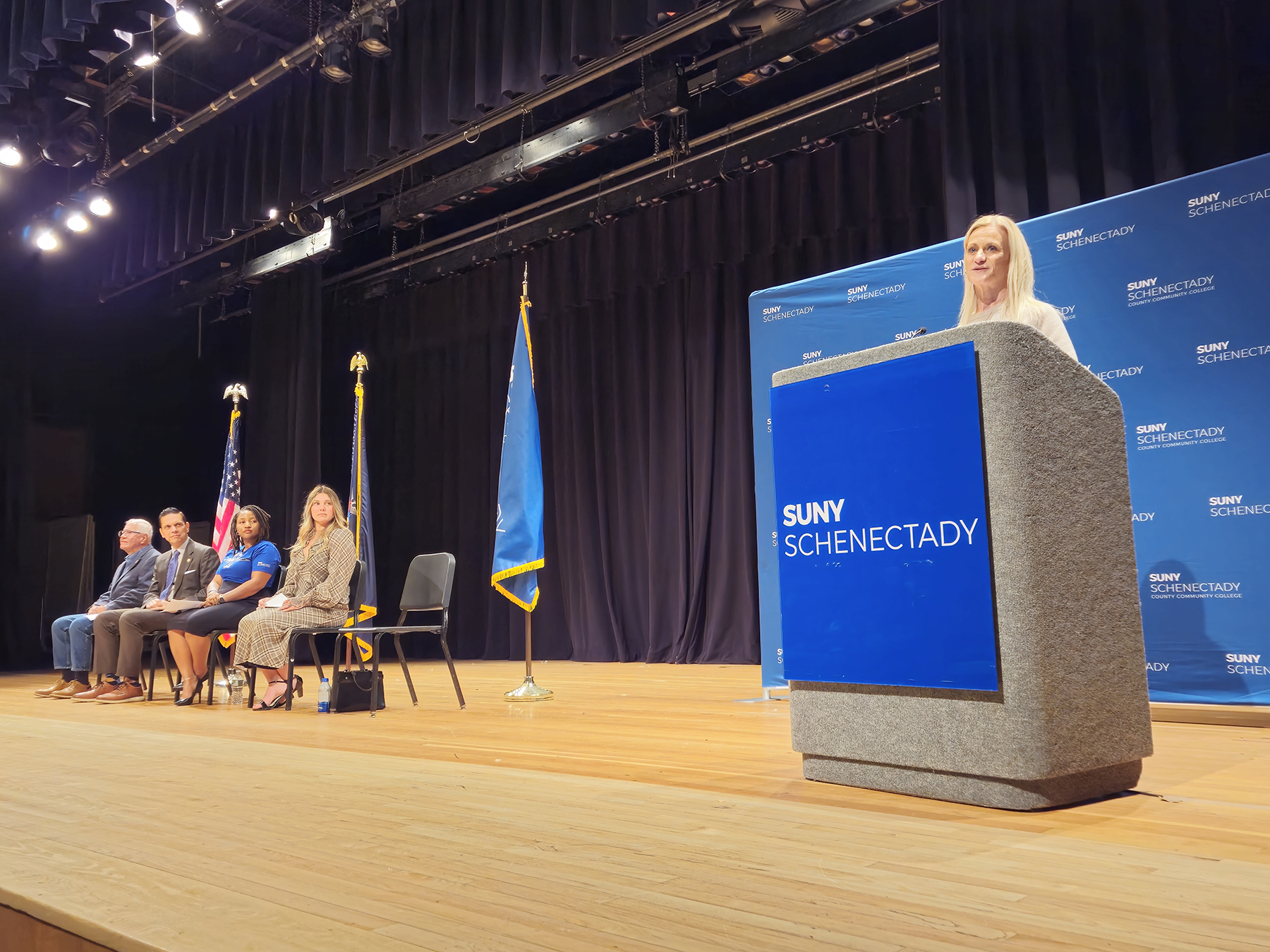 Dr. Jennifer Dr. Jennifer Bashant standing on stage at podium, speaking