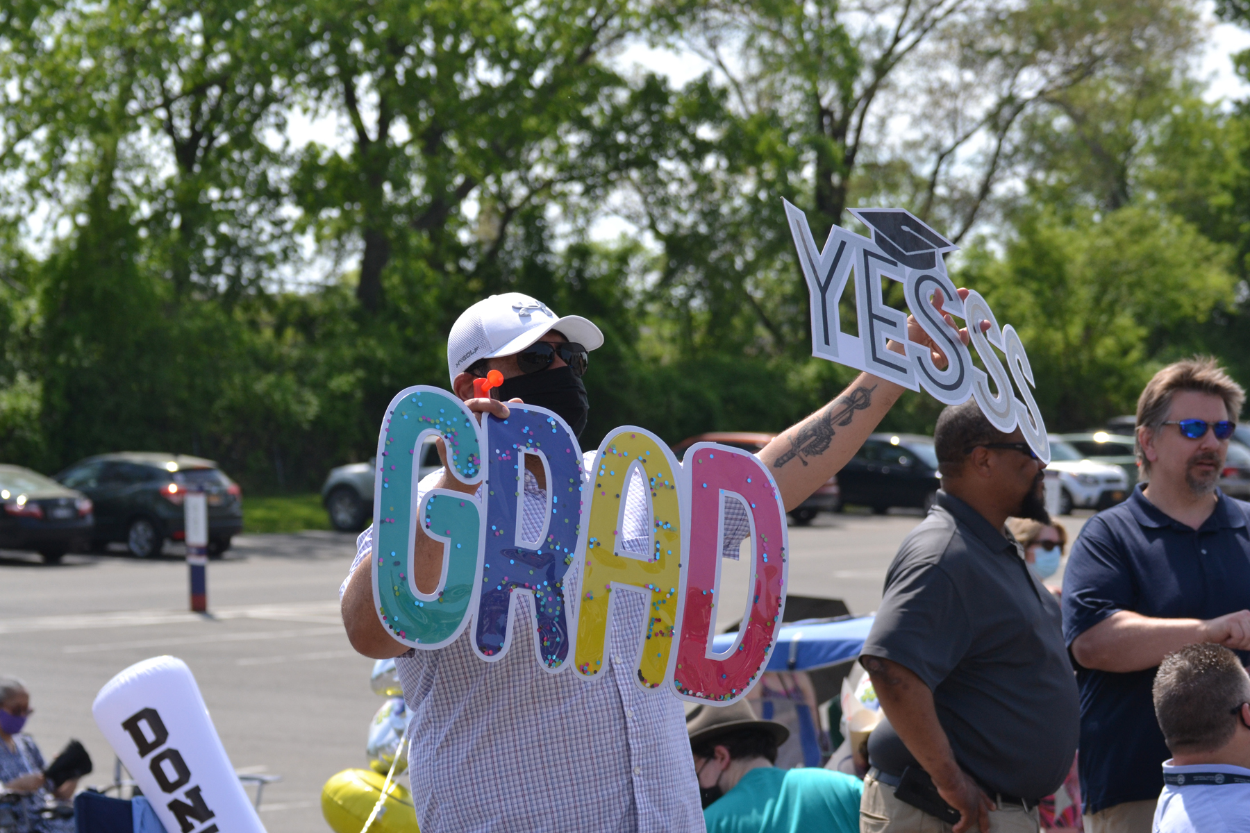 College staff cheering for graduates