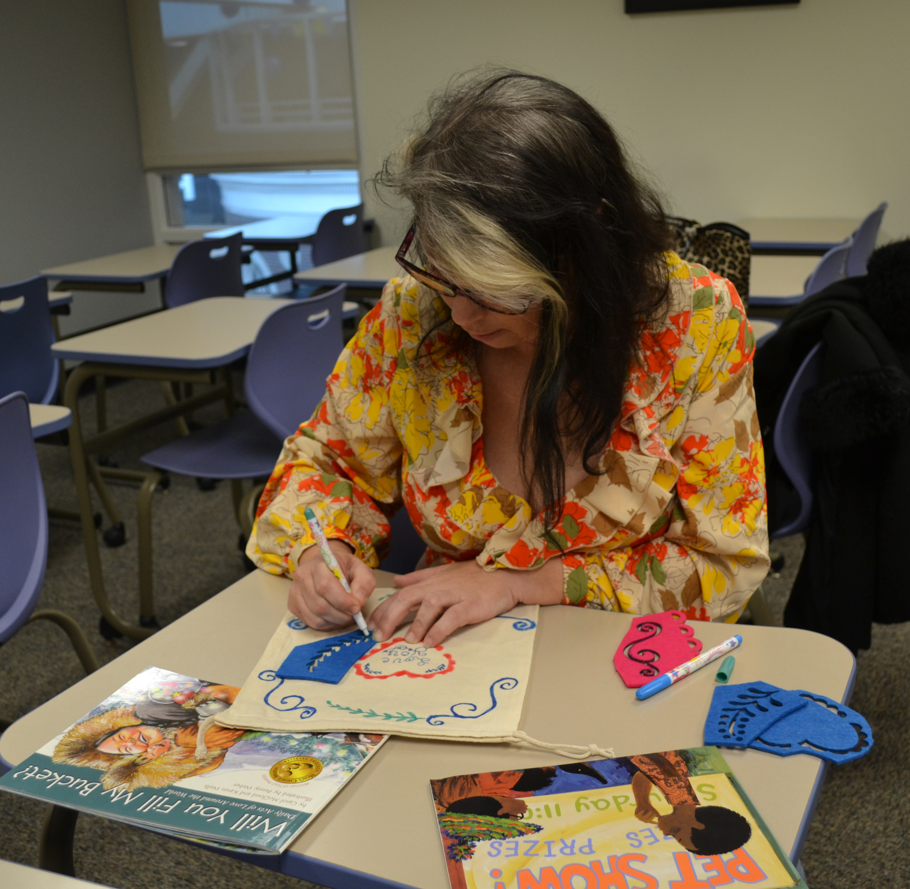 Meghan Mazzariello decorating totebag in classroom