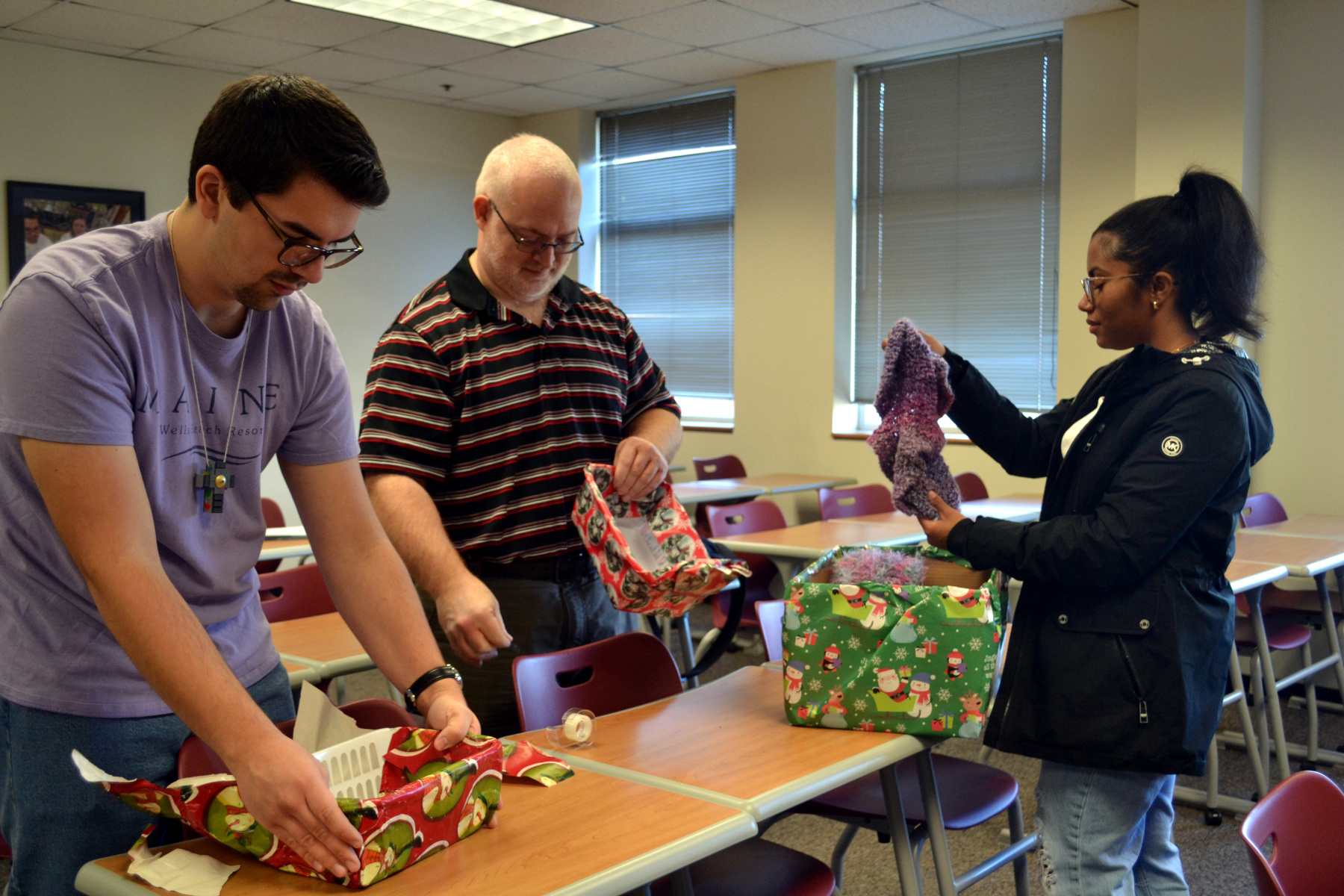 SVO members in clasroom wrapping holiday giveaways