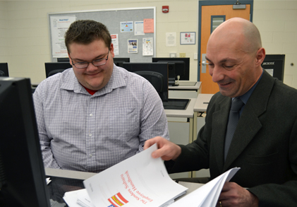 David Sanders, Business Administration major, discusses his business plan with Professor Matt Farron