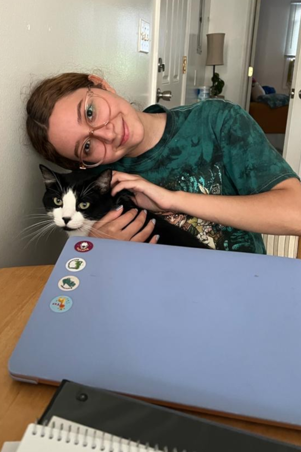 Sara Nava holding cat, smiling