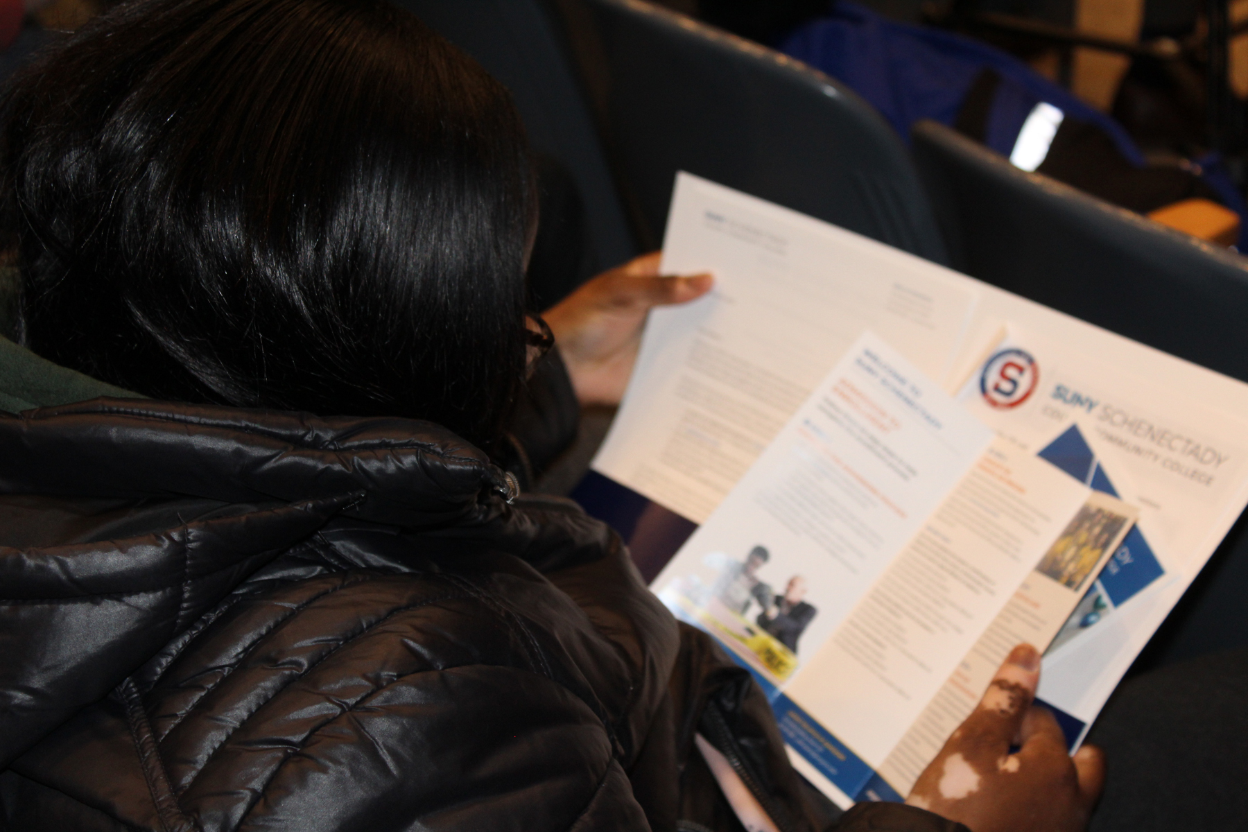 Student holding SUNY Schenectady folder