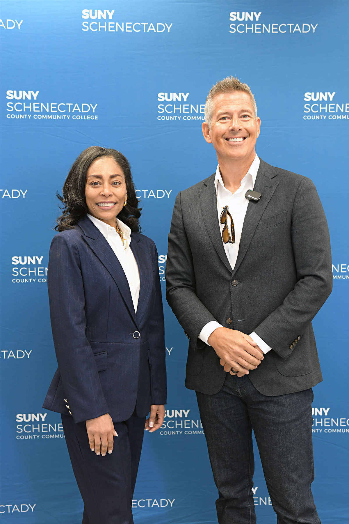 Dr. Nicole Reaves and Secretary Sean Duffy standing in front of SUNY Schenectady backdrop