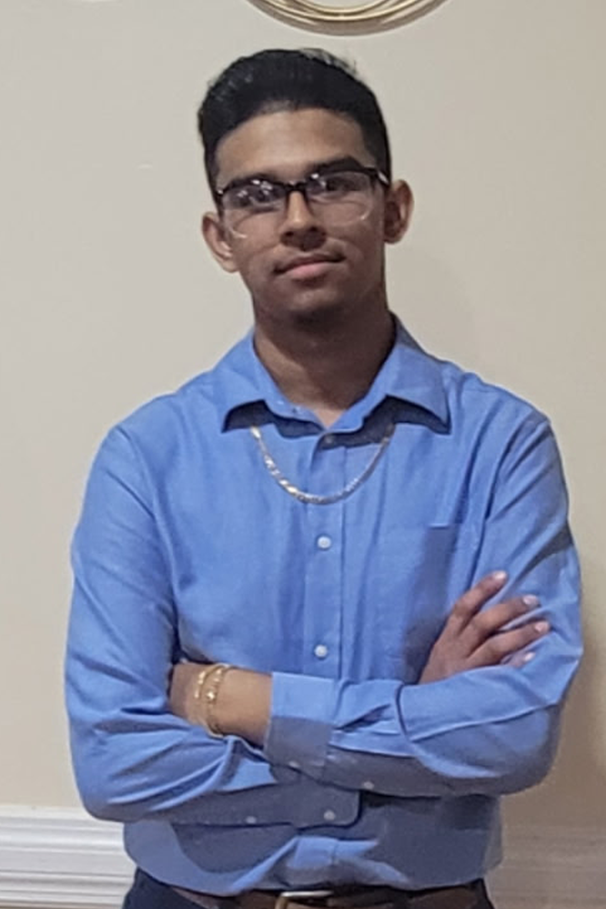 Shivnarine Sukraj standing with arms folded