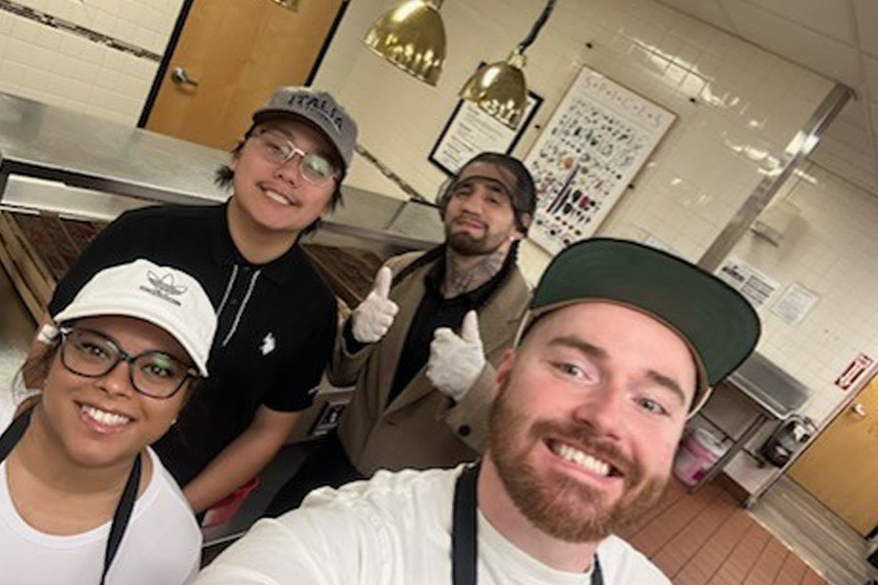 Students smiling, standing in kitche at City Mission