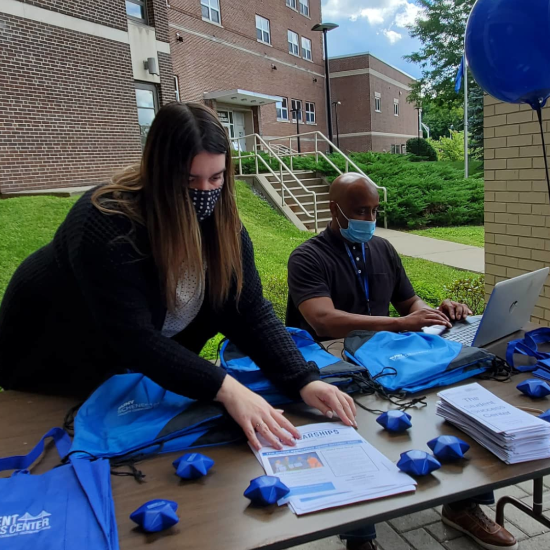 Leanna Liuzzi and Harry Rolle seated at table outside Elston Hall