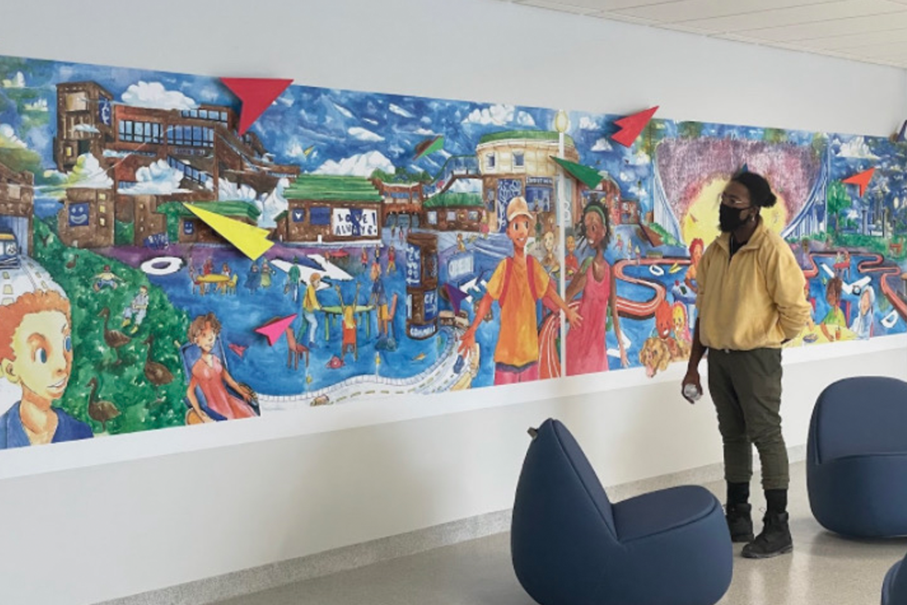 Taiitan with his mural ONE WORLD on University at Buffalo’s north campus, 2022