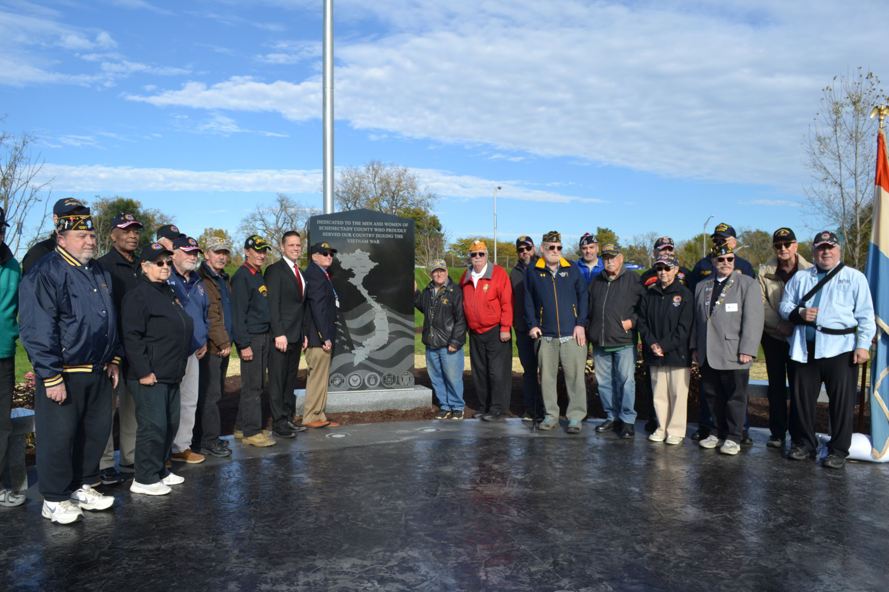 Veterans standing in front of Vietnam Veterans Memorial