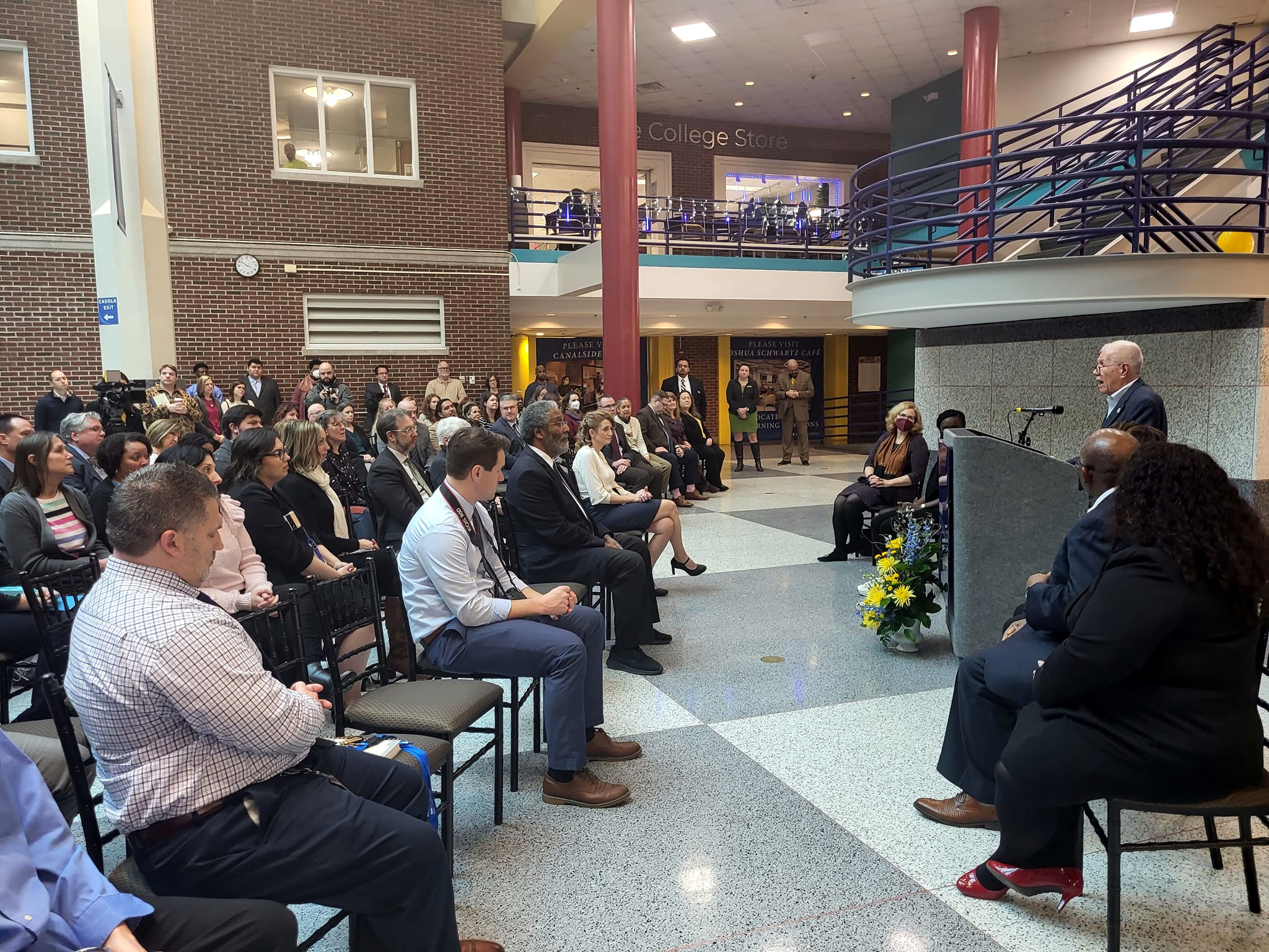 Gary Hughes speaking at podium to audience during Welcome Center Ribbon Cutting