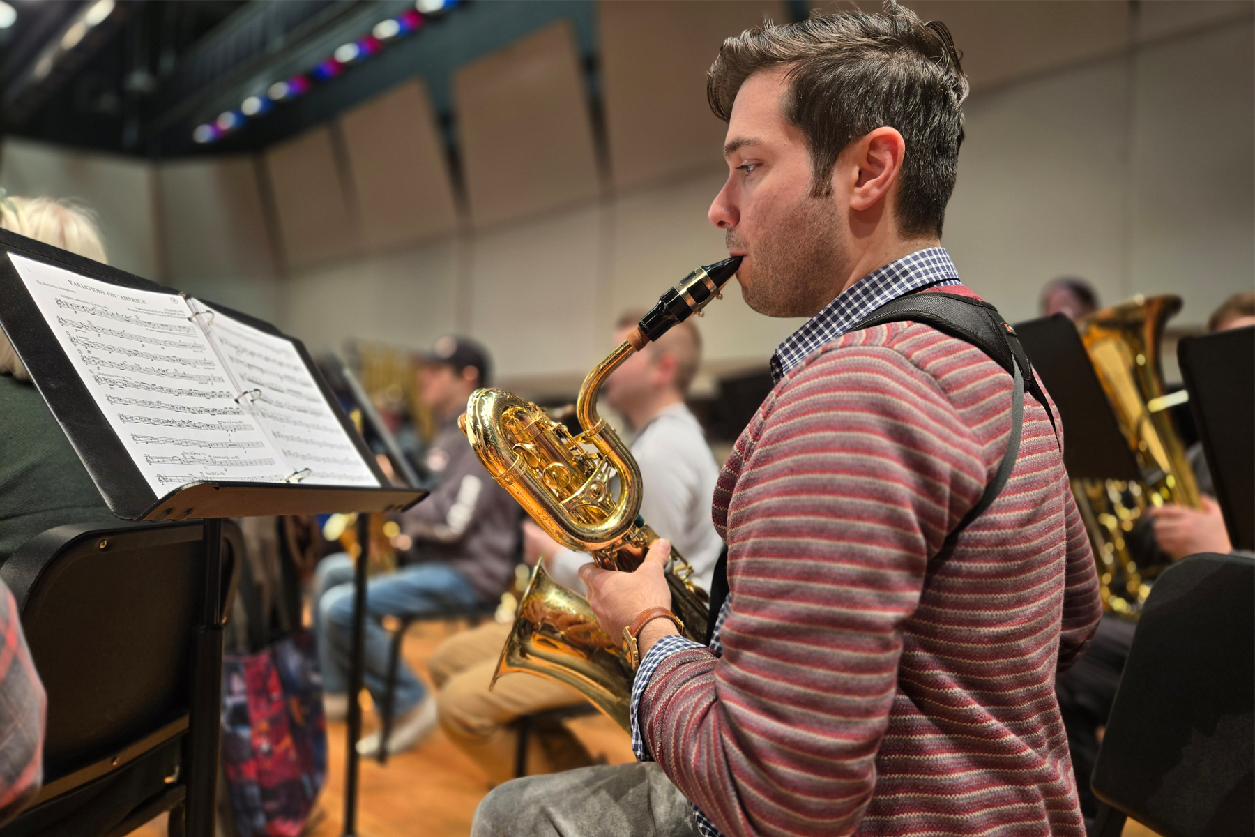 Saxophonist playing on stage during Wind Ensemble rehearsal