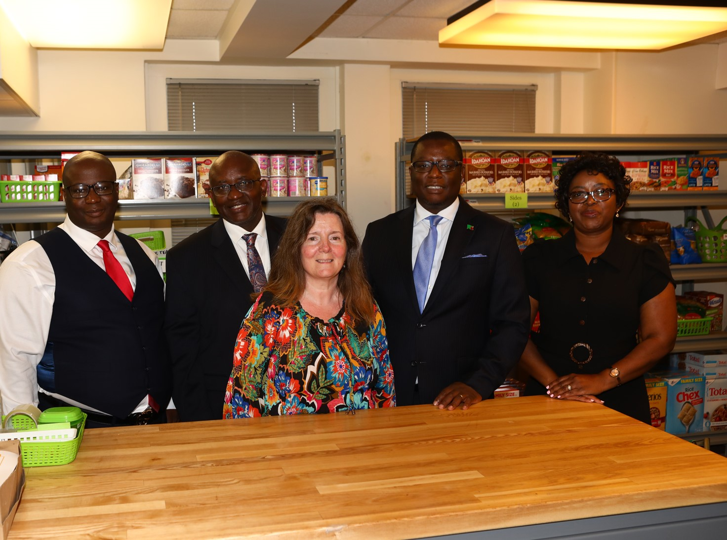 H.E. Amb. Dr. Chola Milambo with staff in the Food Pantry