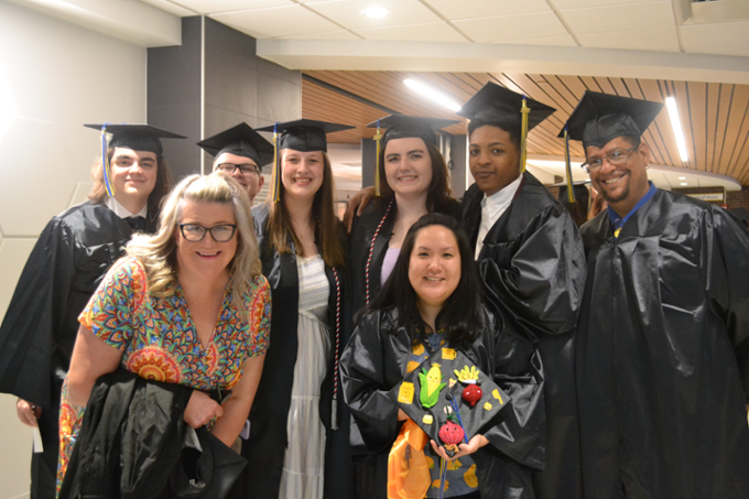 Group of graduates with Kim Otis, Faculty Member