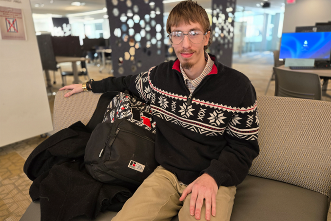 Damien Bennett sitting in Learning Commons