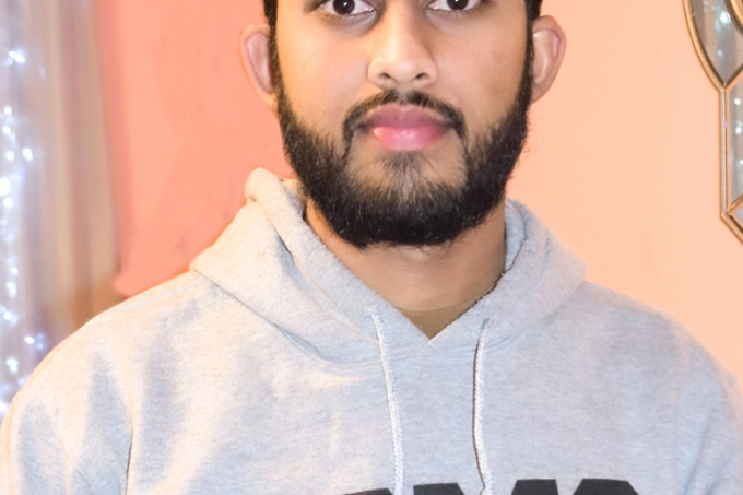 Headshot of Dravid Seecharran wearing USMC sweatshirt.