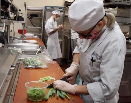 Student chef preparing a delicious meal to-go. 