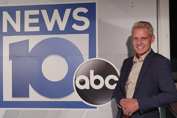 James De La Fuente standing in front of the NEWS10 ABC logo