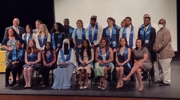 Group photo of students and teachers on stage during Smart Transfer Completion Ceremony