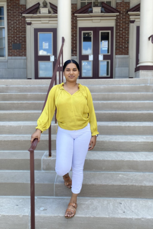 Varsha, SGA Senator on front steps of Elston Hall