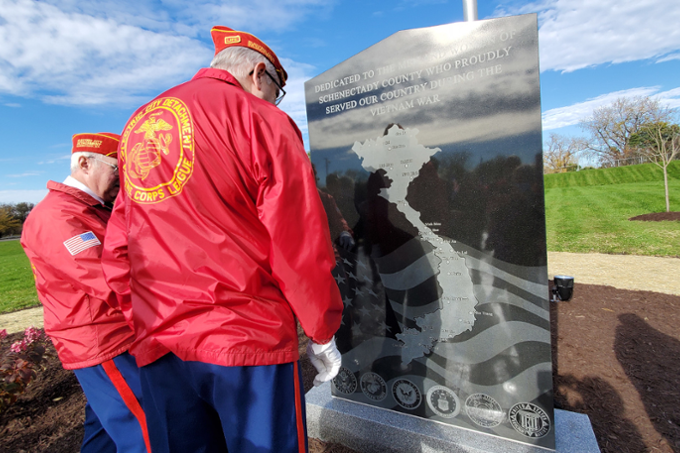 Veterans looking at new Vietnam Veterans Memorial on campus. 