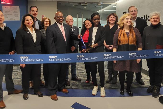 Group photo, College officials and supporters cutting ribbon for new Welcome Center