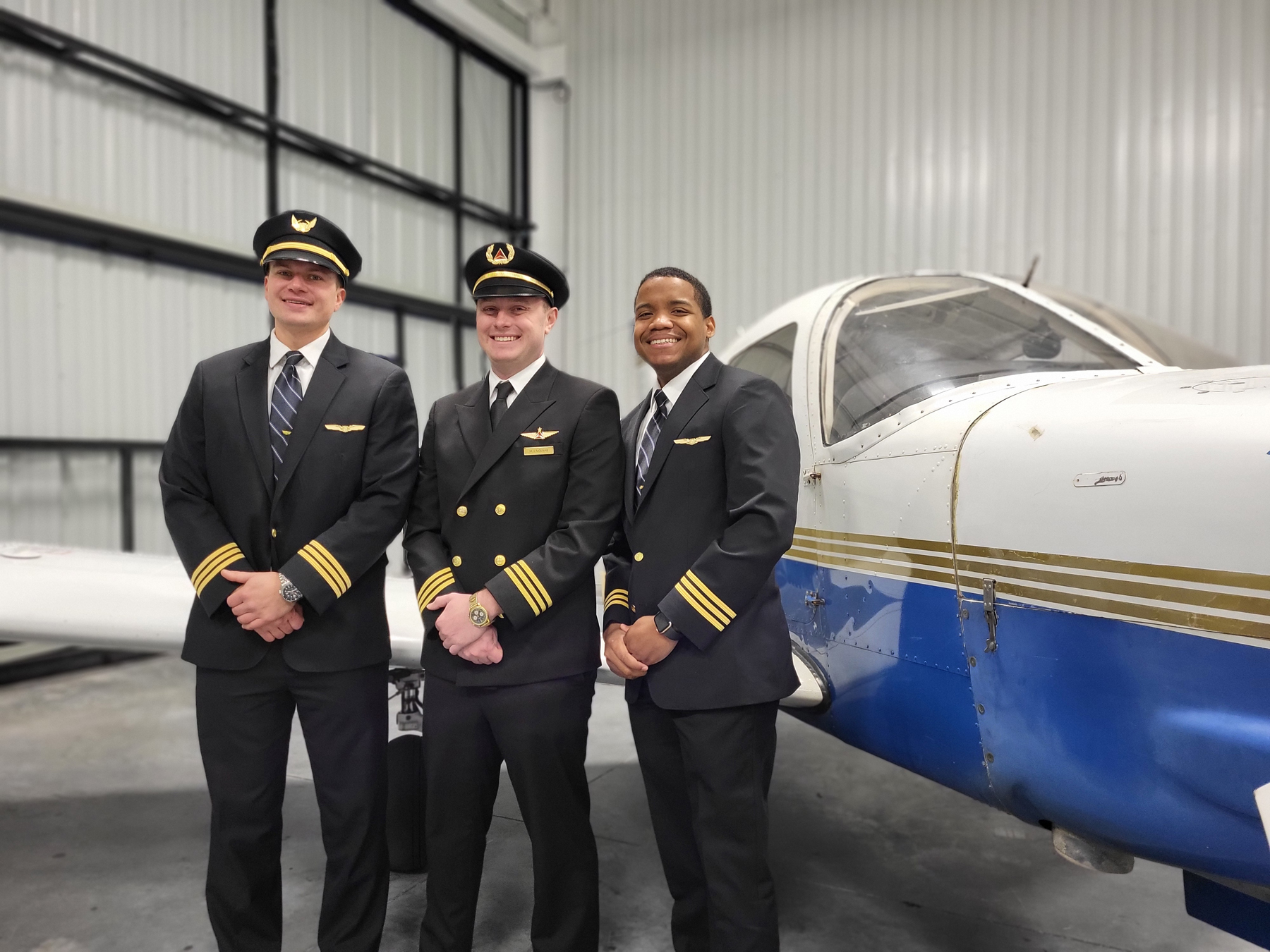 Aviation alumni in front of plane
