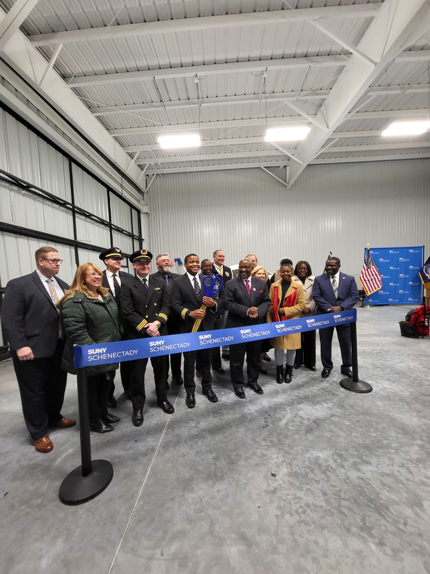 Officials cut the ribbon for the new airport hangar