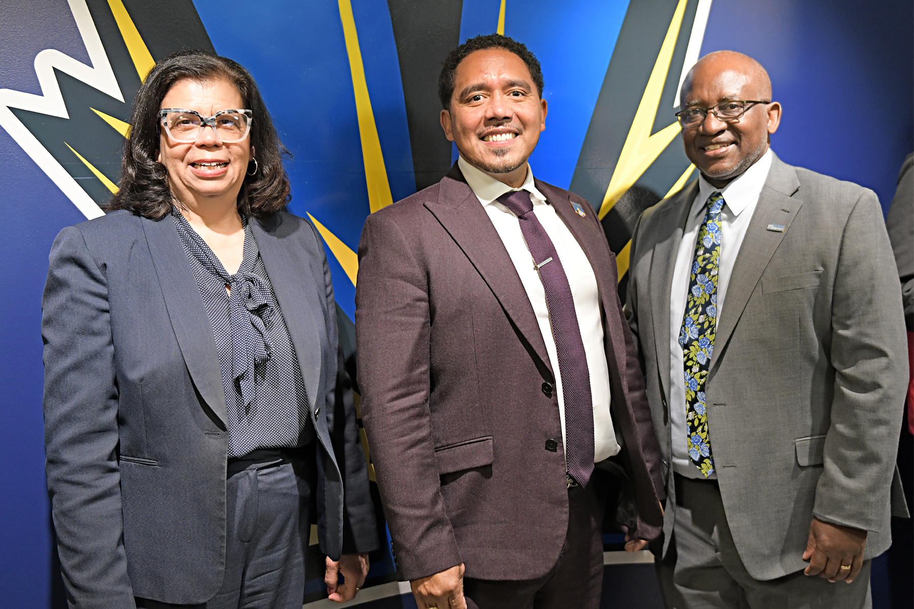 Valerie Dent, Dr. Carlos Cotto, Jr., and Dr. Steady Moono standing in front of eSports logo