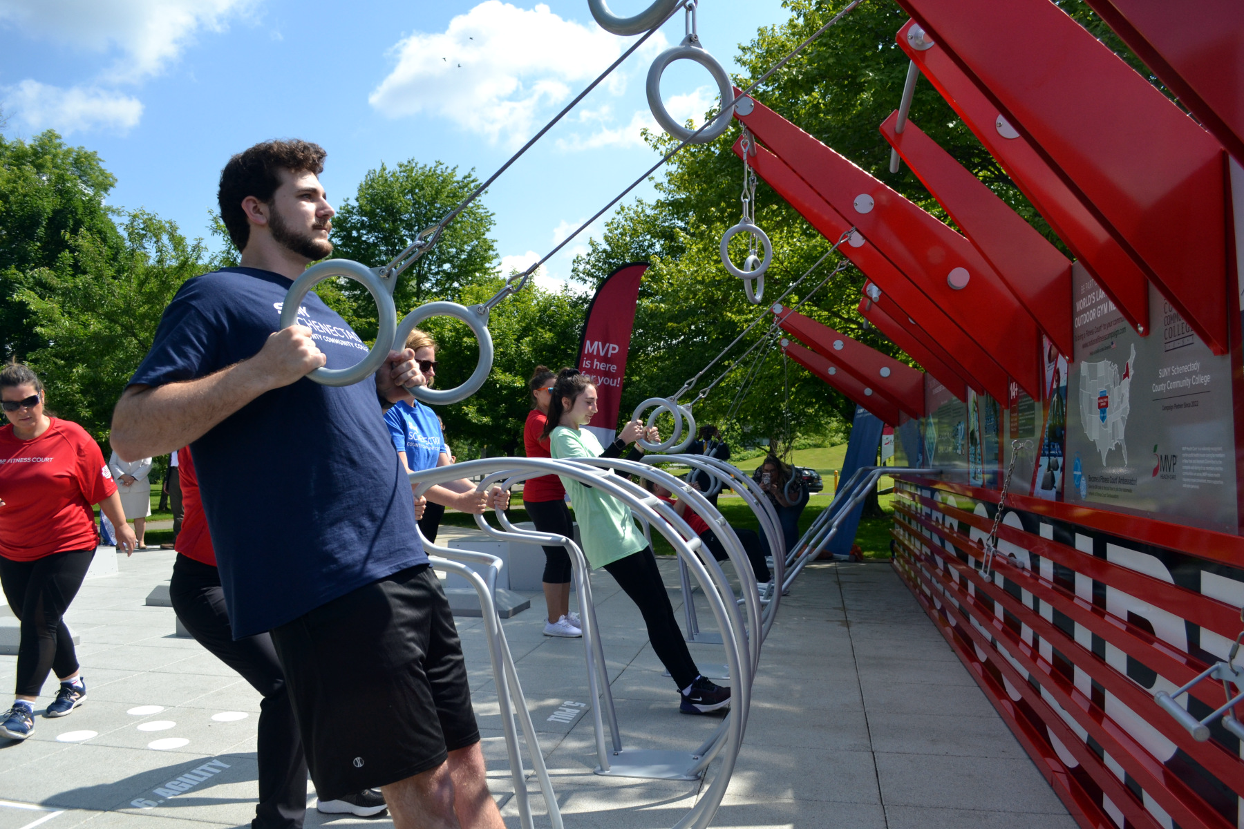 People using rings at MVP Health Care Fitness Court