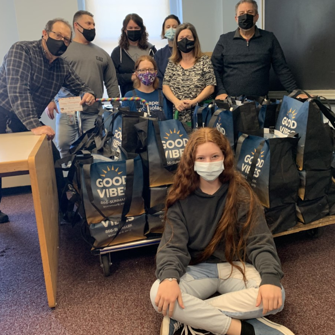 Staff standing in back of assembled meal kits