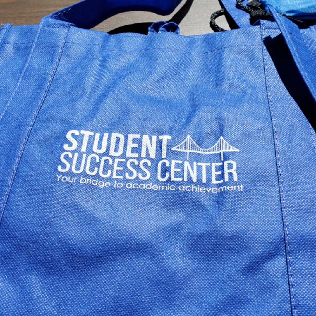 Blue Student Success Center totebag with logo of bridge