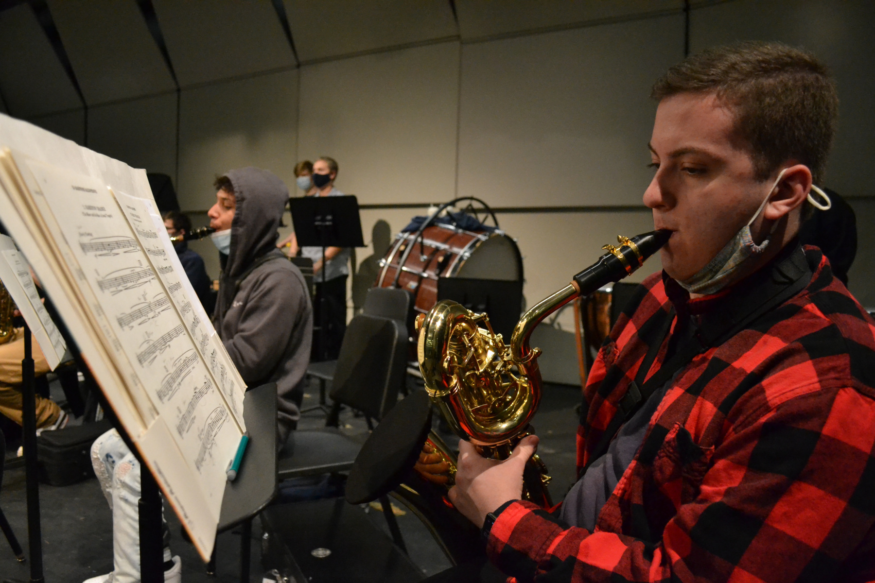 Students in wind ensemble rehearsing in auditorium